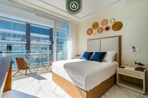 a bedroom with a large bed and a balcony at 3BR Condo Right Next to the Beach - Pool - Palapa in Nuevo Vallarta
