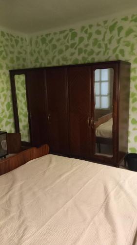 a bedroom with a bed and a large mirror at affittacamere de al vecchio scalo in Isola del Cantone
