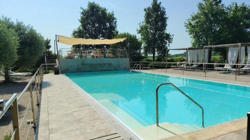 a large blue swimming pool with a bar at B&B Casazze Dream in Marcaria
