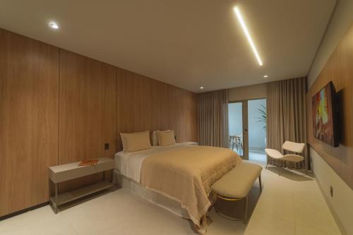a hotel room with a bed and a balcony at Mantra Hotel in Feliz Natal