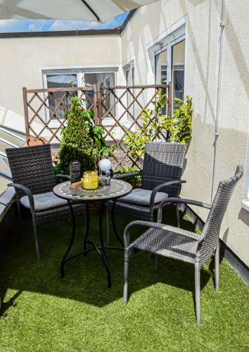 a patio with two chairs and a table and two chairs at Grunau Hotel in Bayreuth