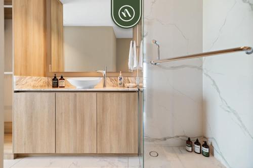 a bathroom with a sink and a shower at New 2BR APT - Beach Access - Pool - GYM - Jacuzzi in Nuevo Vallarta