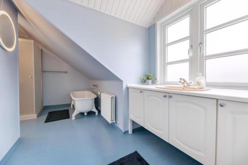 a bathroom with a sink and a toilet at Høloftet - Charming Vacation Apartment On The 1St Floor Of Hawbakken in Hjørring