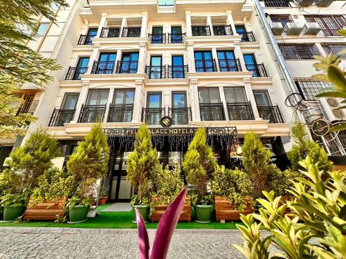 a large building with plants in front of it at Pell Palace Hotel & SPA in Istanbul