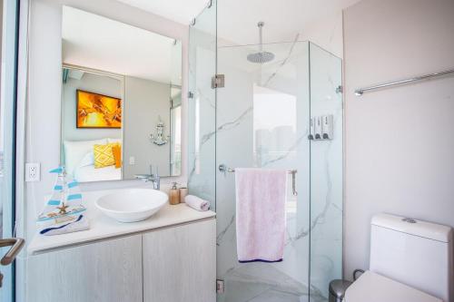 a bathroom with a sink and a glass shower at Nautico nautico 8a in Puerto Vallarta