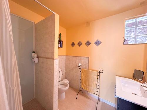 a bathroom with a toilet and a shower at Casa Olivia Sant Lluis in Sant Lluis