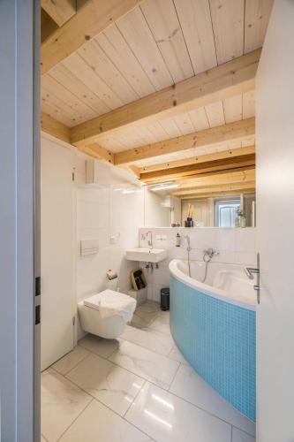 a bathroom with a tub and a toilet and a sink at Apartment in Sankt Moritz in St. Moritz