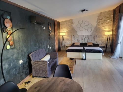 a bedroom with a bed and a table and chairs at Diamona apartment lux sa pogledom na bazen in Donja Toponica