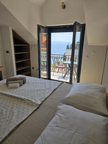 a bedroom with a large bed with a view of the ocean at Villa Aequum in Trogir