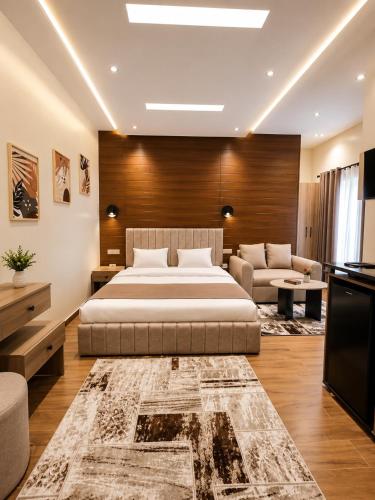 a bedroom with a bed and a living room with a couch at Regal View Residences & Suites in Cairo