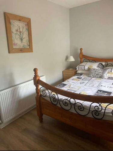 a bedroom with a wooden bed in a room at 7 Main st in Camlough