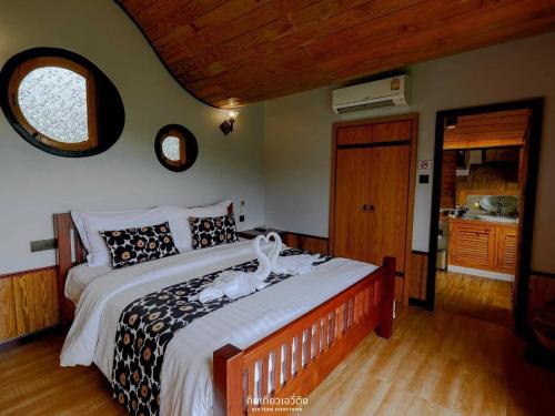 a bedroom with a large bed in a room at Kiri Pura Resort in Phetchabun