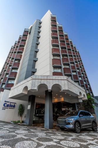 a car parked in front of a building at Hotel Caiuá in Umuarama