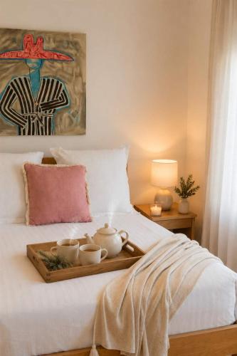 a bed with a tray with tea cups on it at Ocean Views Byron Infused Bliss NEW in Encounter Bay