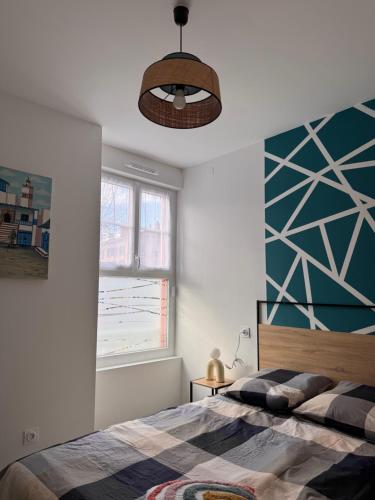 a bedroom with a bed and a large window at 104 - centre de voiron - DeTassigny in Voiron