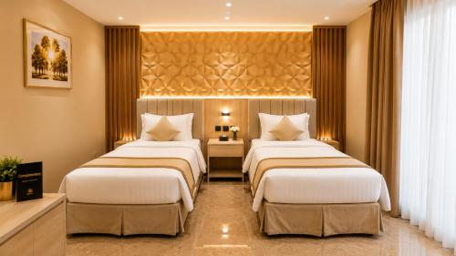 a hotel room with two beds in a room at دار السناء للشقق المخدومة Dar Al Sanaa Serviced Apartments in Jeddah
