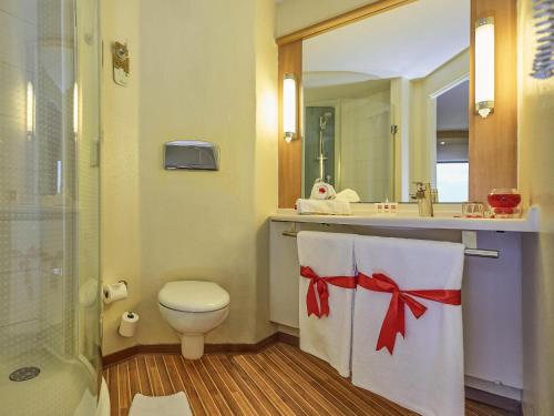 a bathroom with a toilet and a sink at Ibis Antananarivo Ankorondrano in Antananarivo