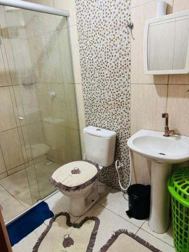 a bathroom with a shower and a toilet and a sink at Meu aconchego in Castanhal
