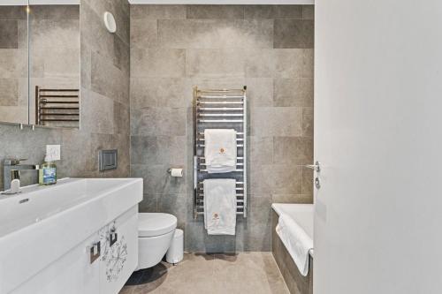 a bathroom with a sink and a toilet and a tub at Apartment in Sankt Moritz in St. Moritz