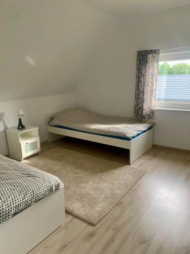 a bedroom with two beds and a window at Domek Adam in Macharce
