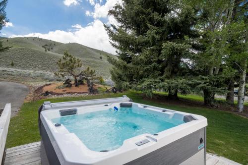 a hot tub on a deck with a view of a mountain at Mountain Mid Century in Sun Valley
