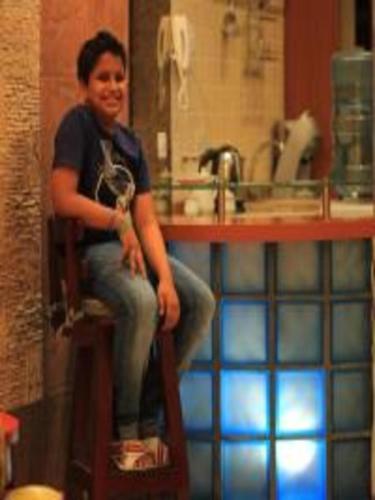 a woman sitting on a chair in a bathroom at اجنحة الخزامى المخدومة in Yanbu