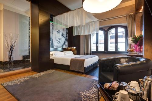 A bed or beds in a room at Dharma Luxury Hotel