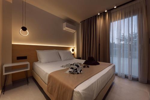 a bedroom with a bed and a large window at Thrive in Sarti