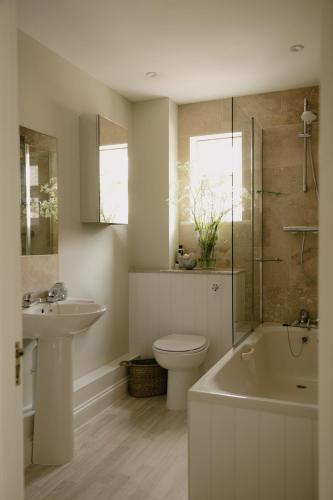 a bathroom with a sink and a toilet and a shower at Central Village Cottage, The Corders in Moreton in Marsh