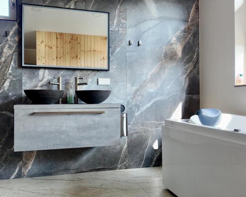 a bathroom with two sinks and a mirror on the wall at Villa Aurelia Spa, Zeewolde 51 in Zeewolde