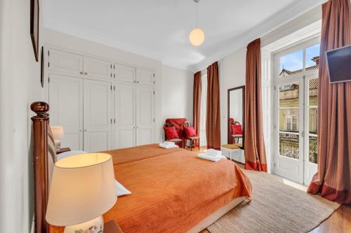 a bedroom with a bed and a large window at Old City Guest House in Braga