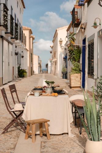 a table and chairs on a street with food on it at CASA CALMA Isla Tabarca - Alicante in Tabarca
