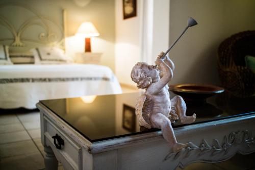 a statue of a little boy playing a baseball at La Bergerie Du Cap in Cap d'Agde