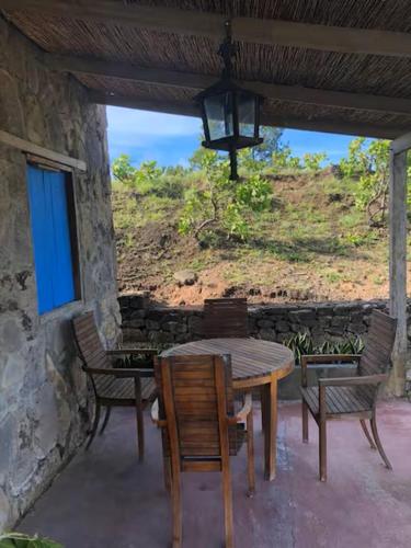 a wooden table and chairs on a patio at Casa Paz by Otium in La Cruz
