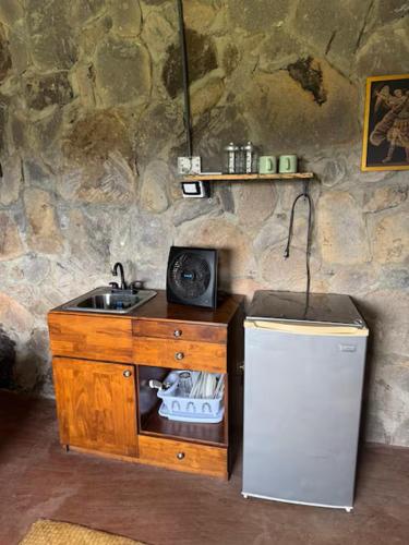 a kitchen with a sink and a refrigerator at Casa Paz by Otium in La Cruz