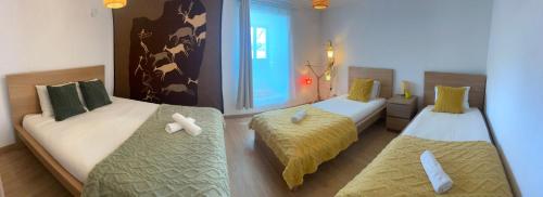 a room with two beds and a window at Casa con parra de uva y paz in Grou
