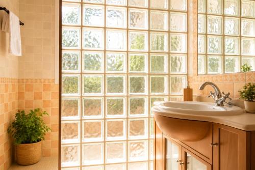 a bathroom with a sink and a large window at La Casona del Bullaque in El Robledo