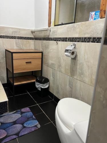 a bathroom with a toilet and a sink at Casa Salkantay Cusco in Cusco