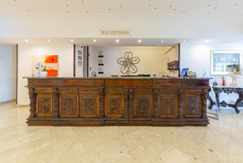 a large wooden cabinet in a room with a museum at Hotel Sakura, Sure Hotel Collection by Best Western in Torre del Greco