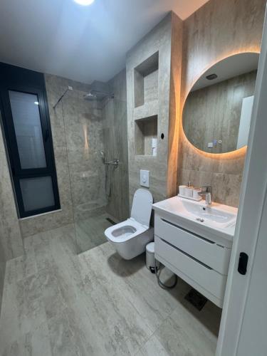 a bathroom with a toilet and a sink and a shower at Prestige Lux Apartment in Bijela Glavica