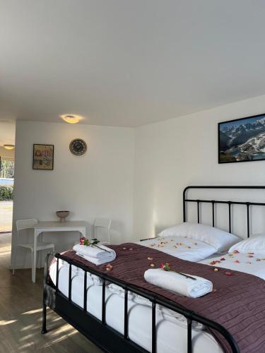 a bedroom with two beds with towels on them at Harderkulm in Interlaken