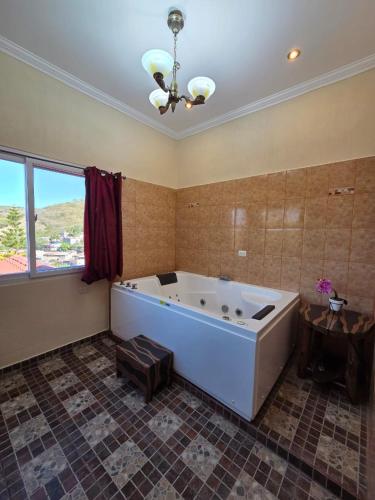 a large bath tub in a room with a window at Hotel y Restaurante Donde Pilo in Santa Rita