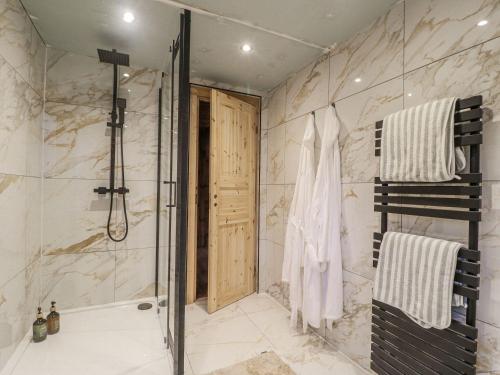 a bathroom with a shower and a walk in shower at Badger's Burrow in Oakham
