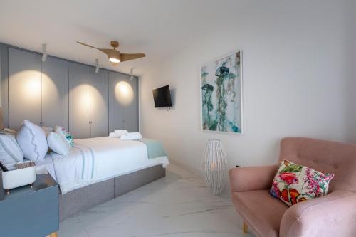 a bedroom with a bed and a couch and a chair at Casa Victoria · Golf, Sun and Sea Breeze. Mojácar in Mojácar