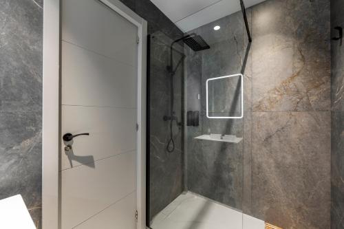 a shower with a glass door in a bathroom at Casa Victoria · Golf, Sun and Sea Breeze. Mojácar in Mojácar