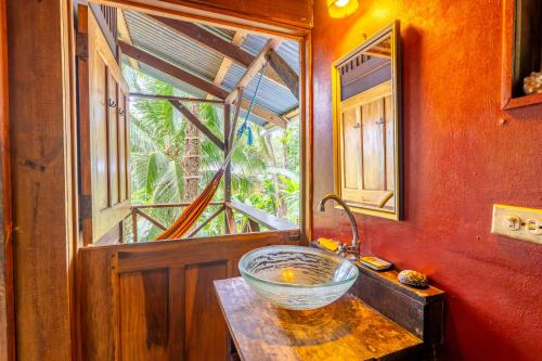 a bowl on a table in a room with a window at Pure Roots in Bastimentos
