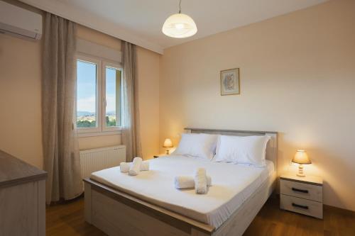 a bedroom with a bed with two towels on it at Maisonette ELINA in Corfu