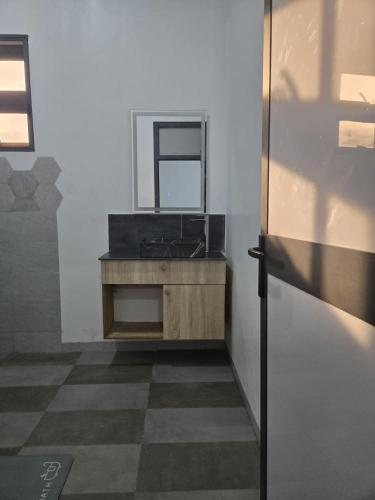 a bathroom with a sink and a mirror on a counter at Villa Princess Goofy in Lomé