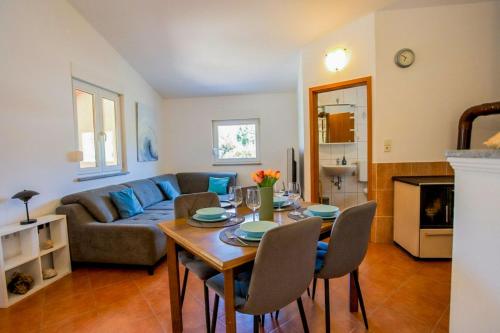 a living room with a table and a couch at Casa Oliva Kim Marie /w Garden - Happy Rentals in Medulin