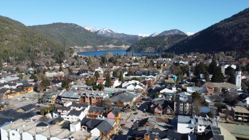an aerial view of a town with a lake and mountains at Departamentos - Belgrano 810 in San Martín de los Andes